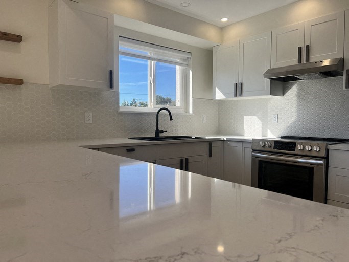 a kitchen with a counter and a stove and a window