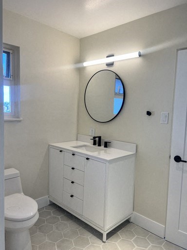 a bathroom with a sink and a mirror and a toilet