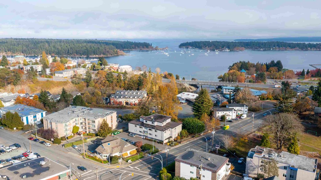 an aerial view of a city with a lake in the background