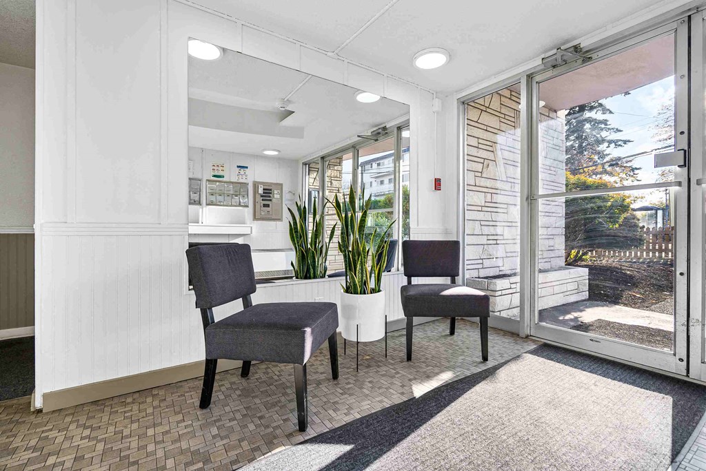a waiting room with two chairs and a window