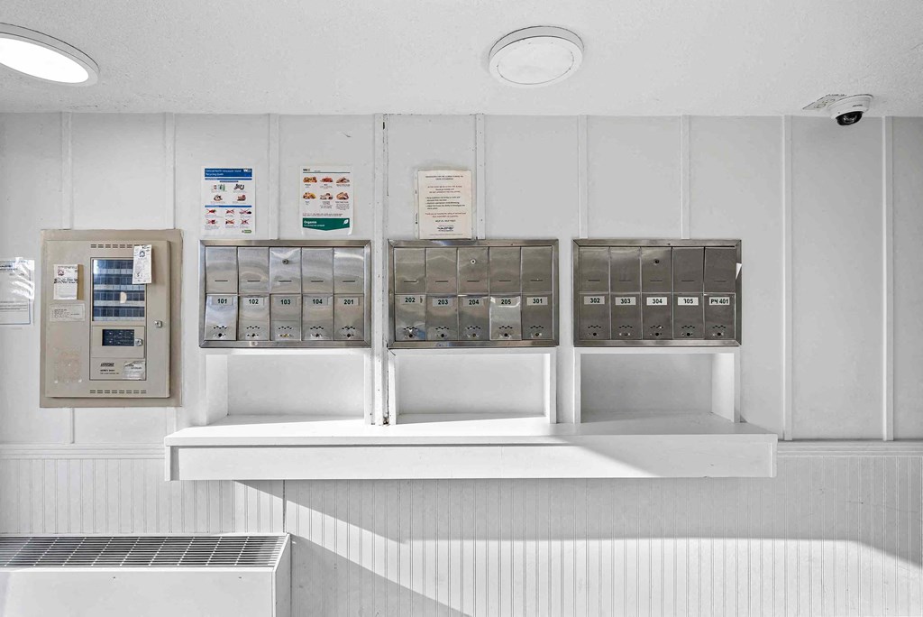 a row of mailboxes on a wall in a white room