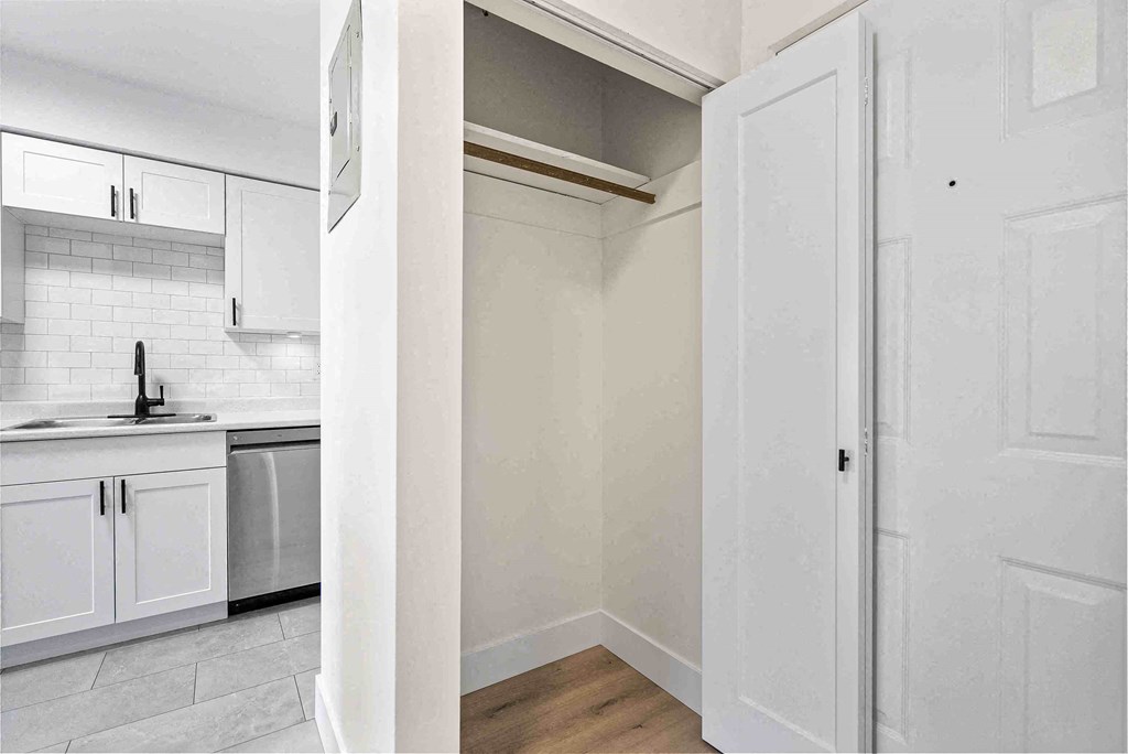 a kitchen with white cabinets and a white refrigerator