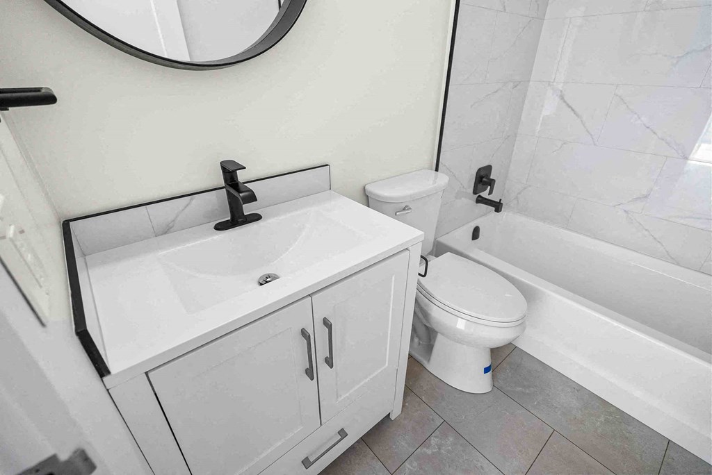 a bathroom with a sink toilet and a bath tub