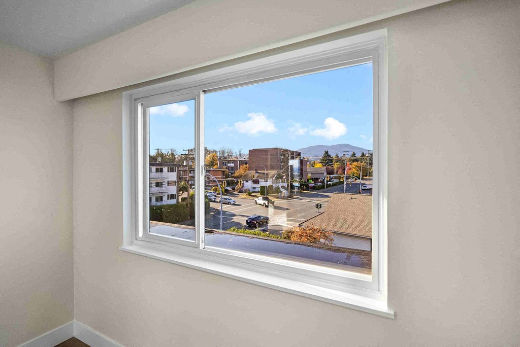 a large window in a room with a city view