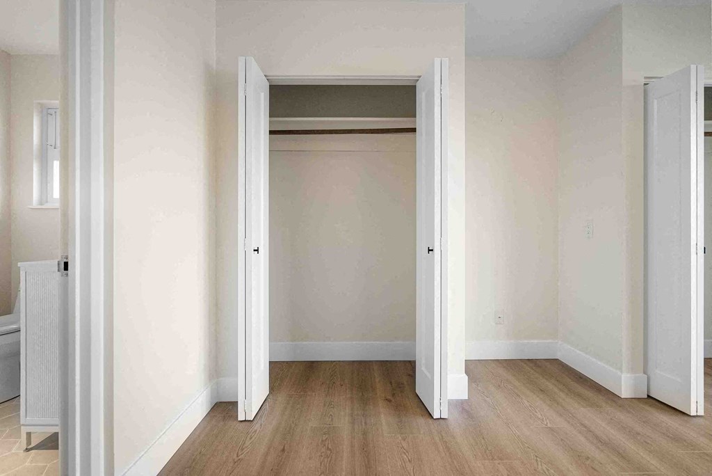 an empty room with an open closet door