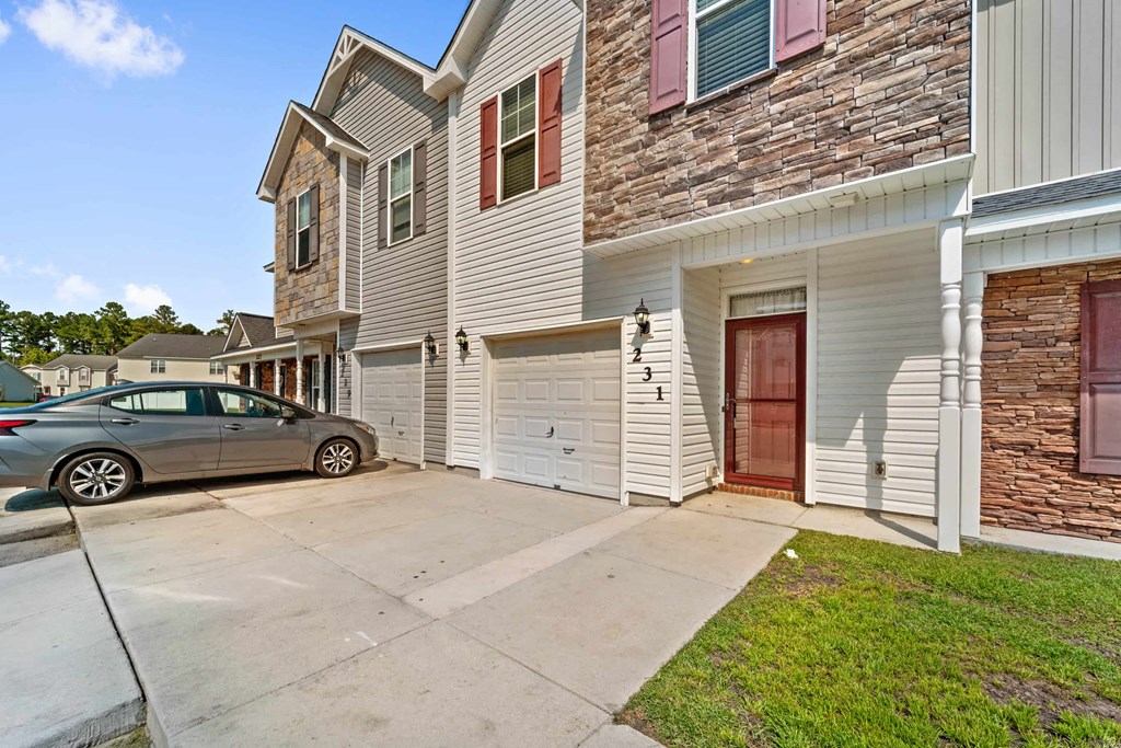 a car parked in front of a building with a garage door