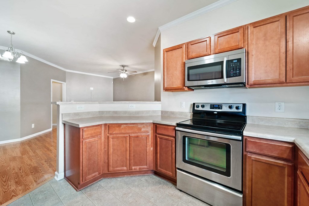 a kitchen with stainless steel appliances and wooden cabinets