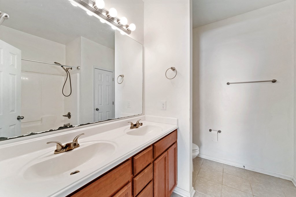 an empty bathroom with a sink and a mirror