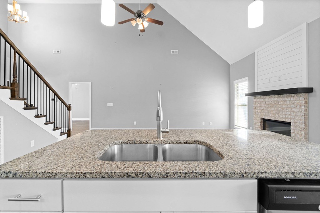 the kitchen of a new home with a granite counter top