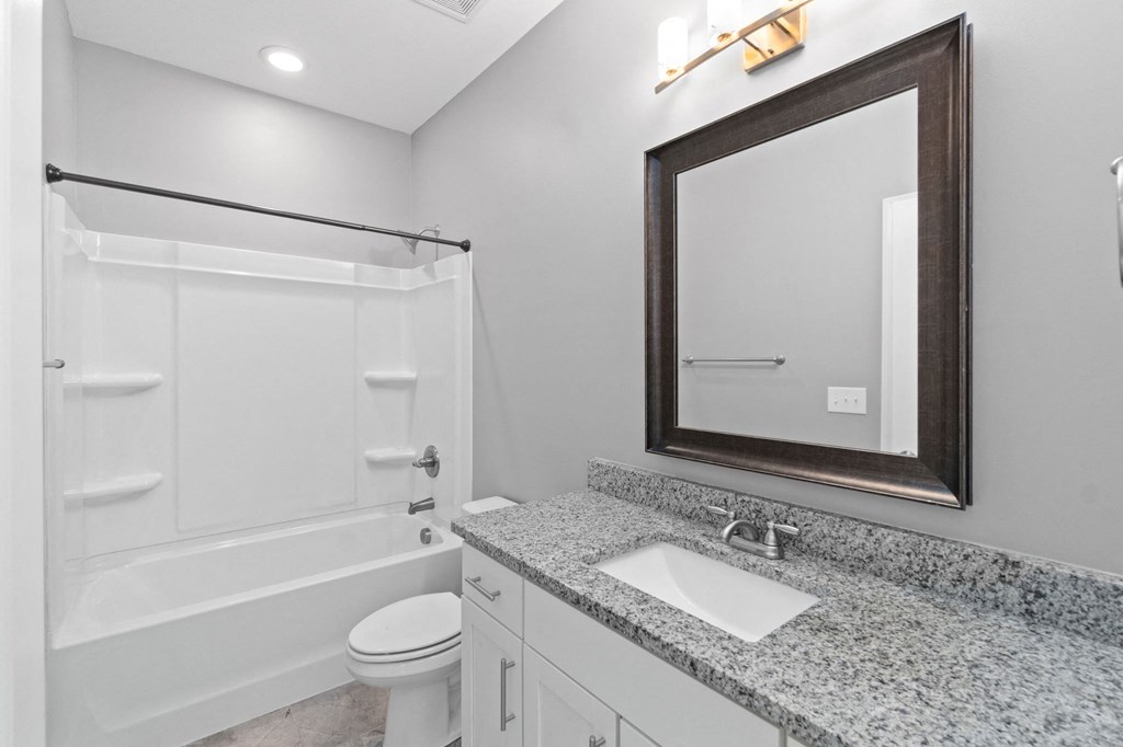 a white bathroom with a sink and a mirror