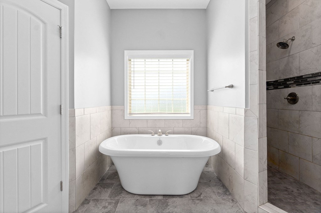 a small bathroom with a tub and a shower