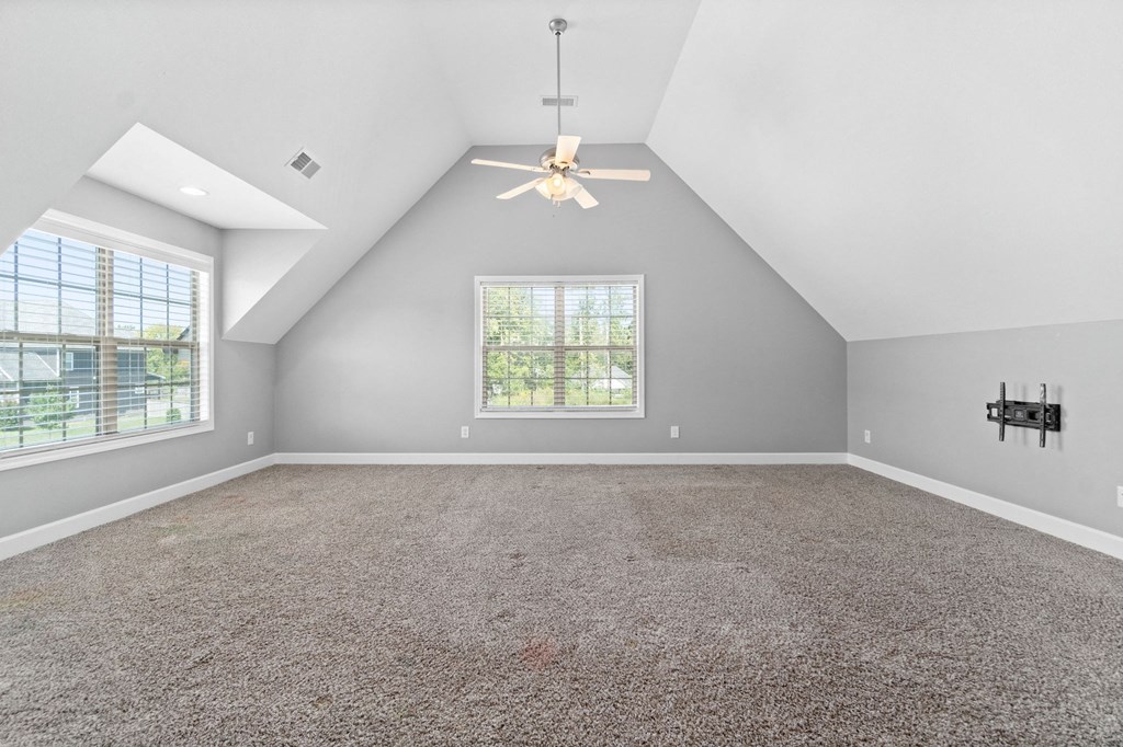 the livable room with carpet and a ceiling fan