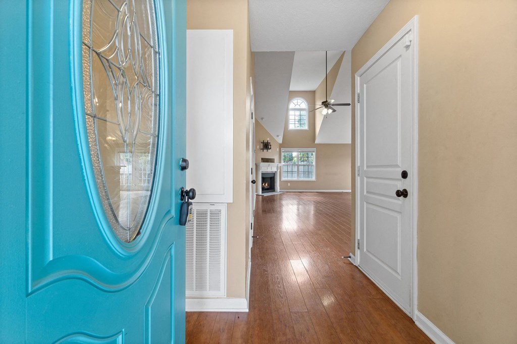 a view of a hallway from a house with a blue door