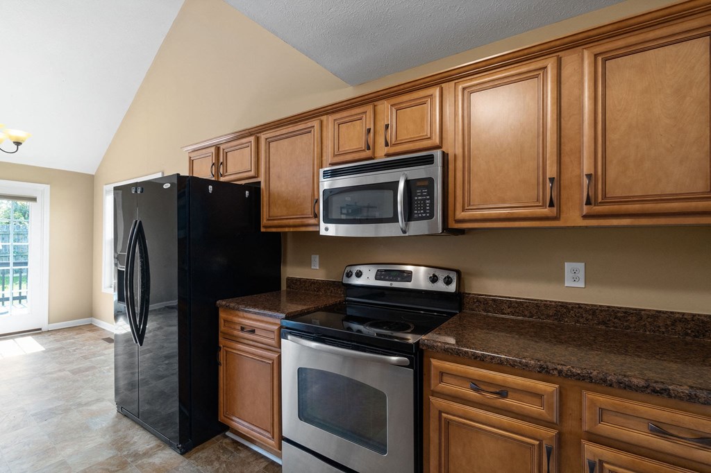 a kitchen with stainless steel appliances and wooden cabinets