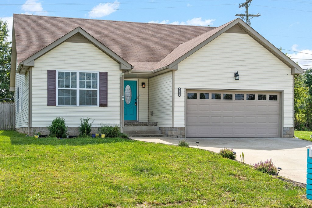 a white house with a driveway and a garage door