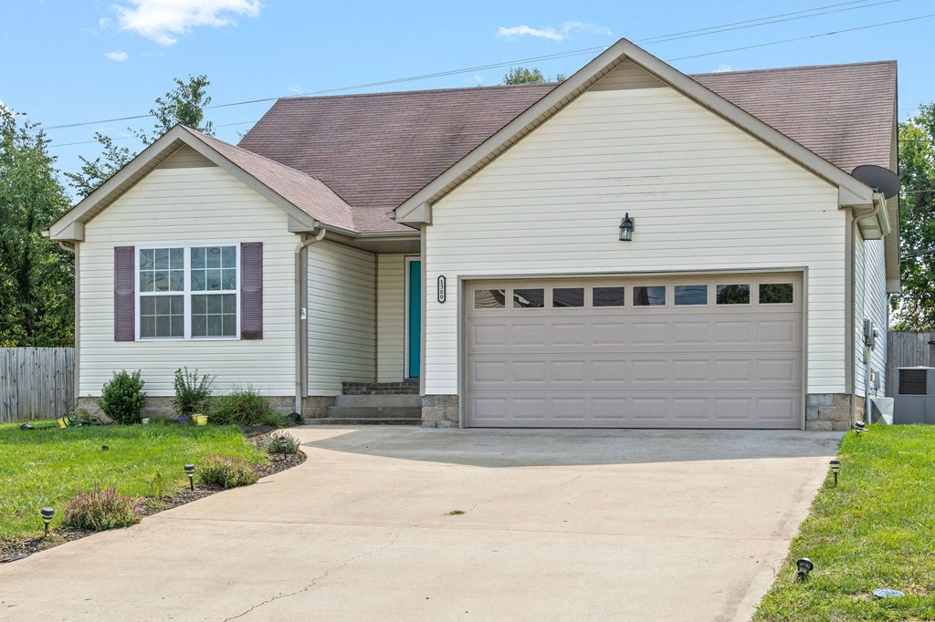 a white house with a driveway and a garage door