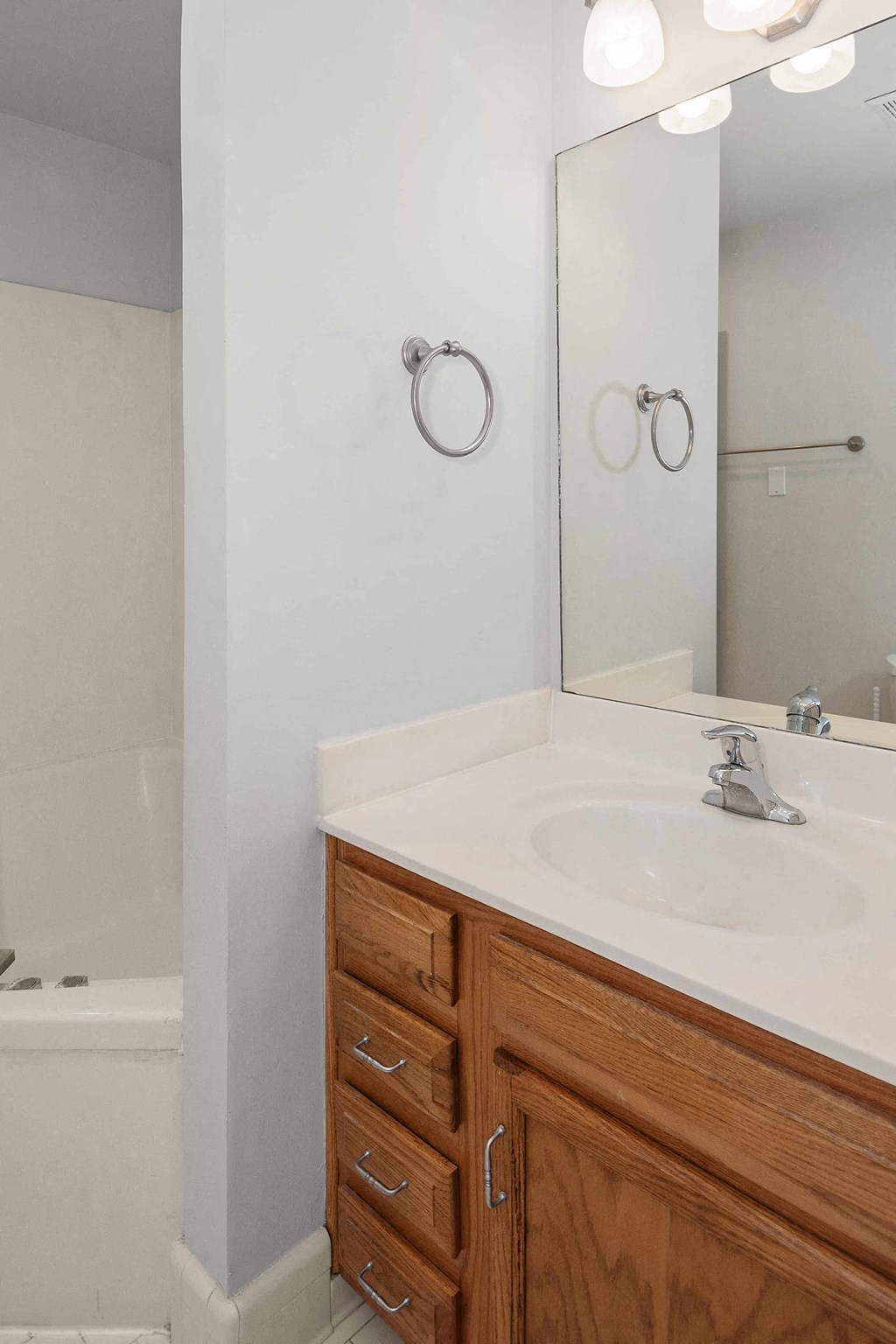 A bathroom with a white sink and a mirror.