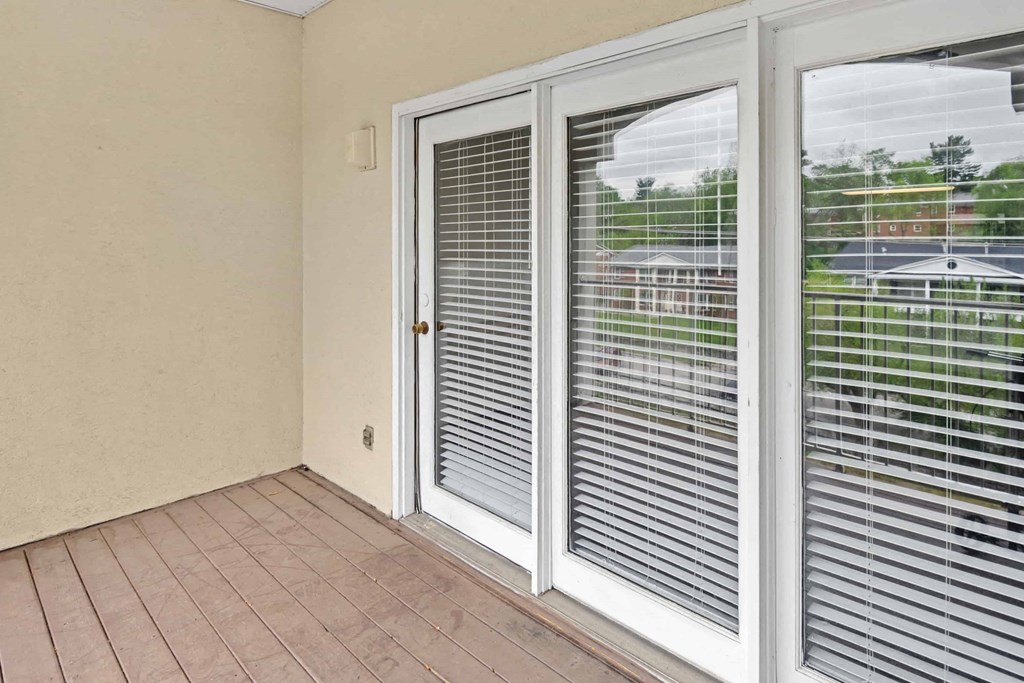 A patio with a sliding glass door.