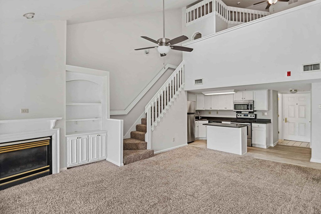 A living room with a staircase leading to the upper floor.