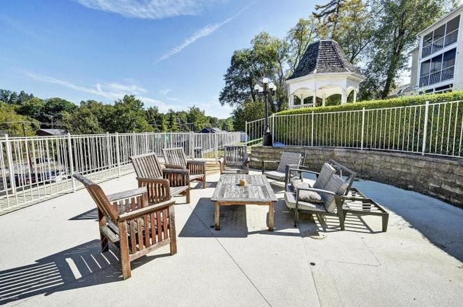 A sunny day at a park with a gazebo in the background.