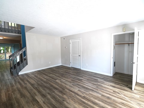 A room with wooden flooring and white walls.