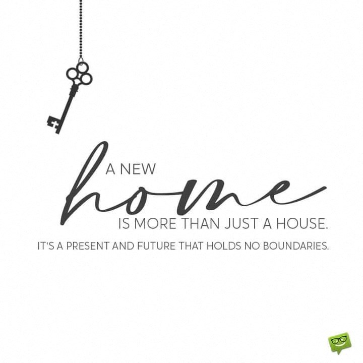 A key hanging with a quote about a new home.