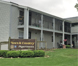a building with a sign for town  country apartments