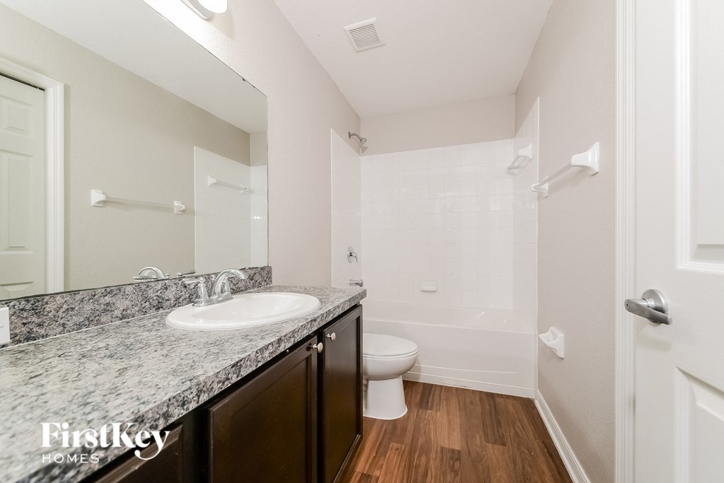 a bathroom with a sink and a toilet and a shower