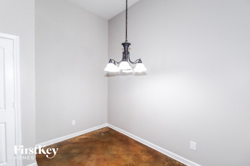 A room with a light fixture hanging from the ceiling.