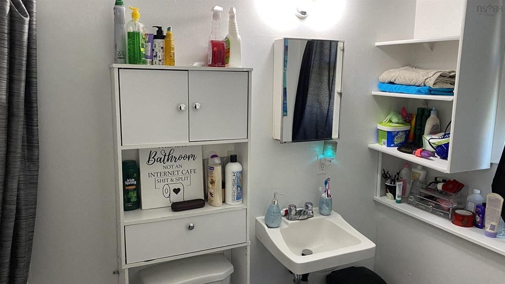 a small bathroom with a sink and a mirror