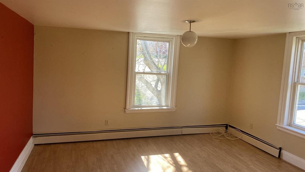 an empty room with a large window and a lamp