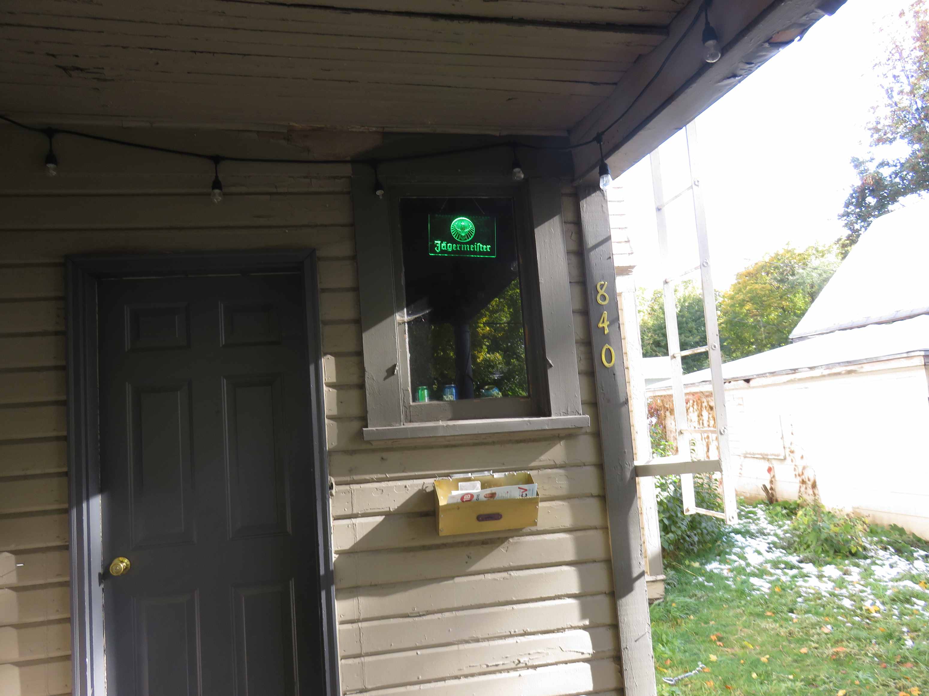 A green sign on a house reads "Telecommunications".