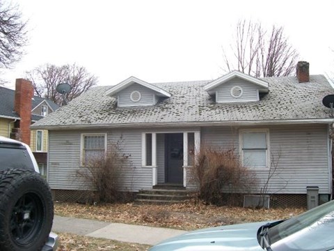 a white house with two dormers on top of it