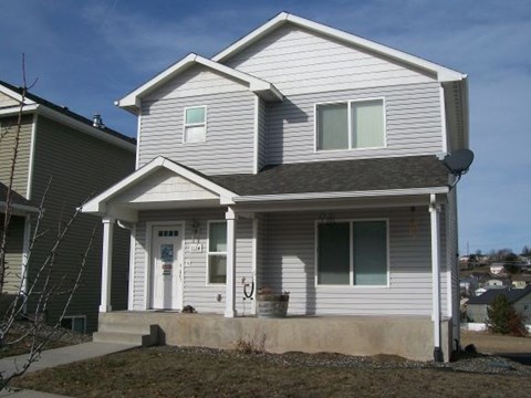 a white house with a sidewalk in front of it