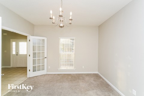 a dining room with a chandelier and a window