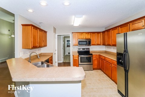 a kitchen with stainless steel appliances and wooden cabinets
