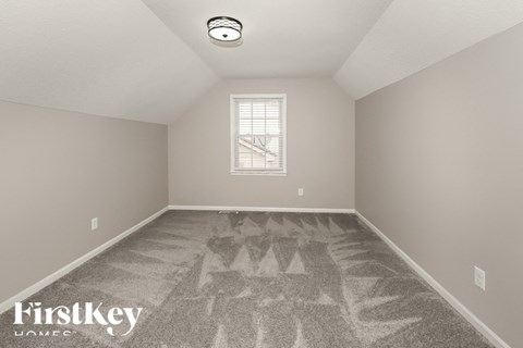 a bedroom with a carpeted floor and a window