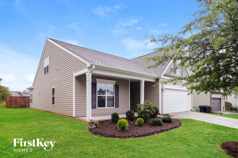 A house with a well-maintained lawn and a clear sky.