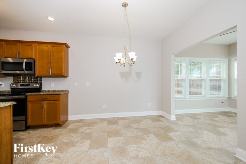 A kitchen with wooden cabinets and a tiled floor.