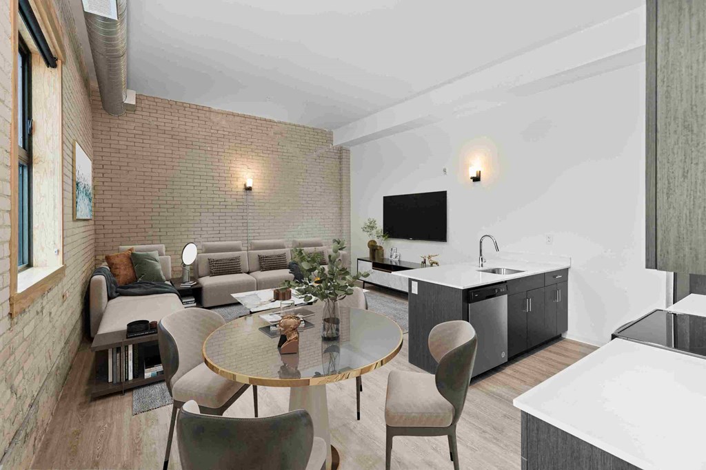 a living room and dining room with a table and chairs