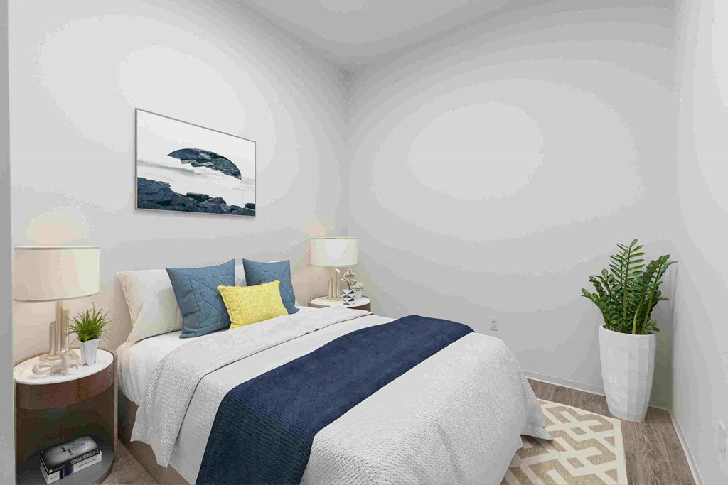 a bedroom with a bed and a potted plant