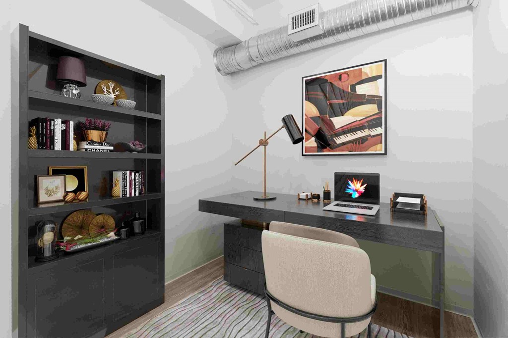 a study area with a desk and a chair and a laptop