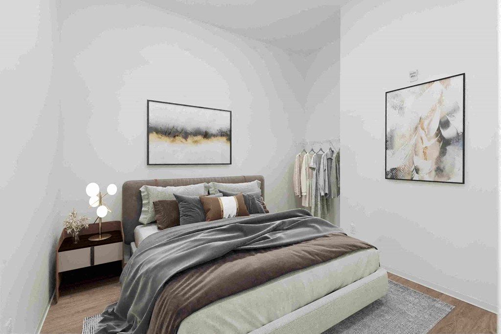 a bedroom with a bed and pictures on the wall