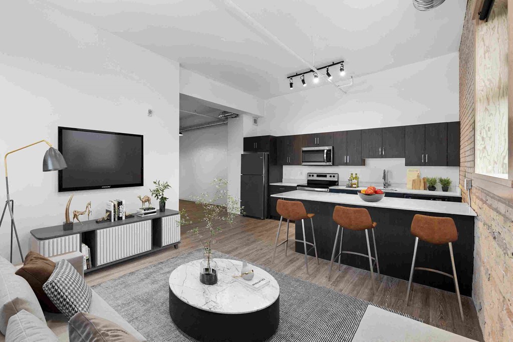 a living room with a kitchen and a television