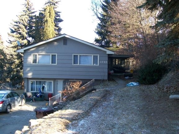 a house on the side of a hill with trees