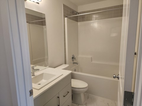 a bathroom with a sink toilet and shower