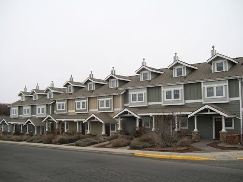 A row of houses with grey and white exteriors.