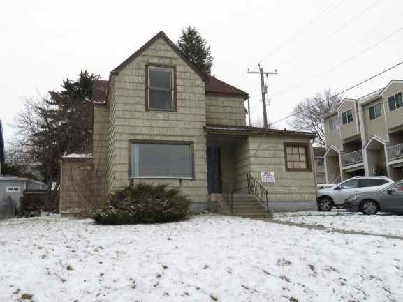 a small yellow house in the snow