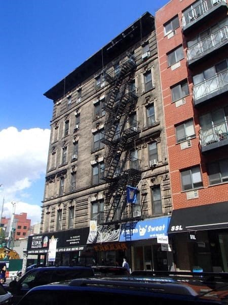 a tall building with a fire escape on the side of it