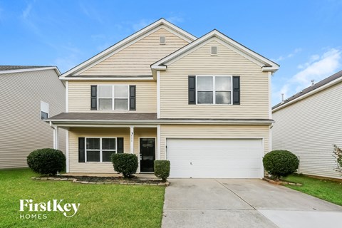 A two-story house with a garage is for sale.
